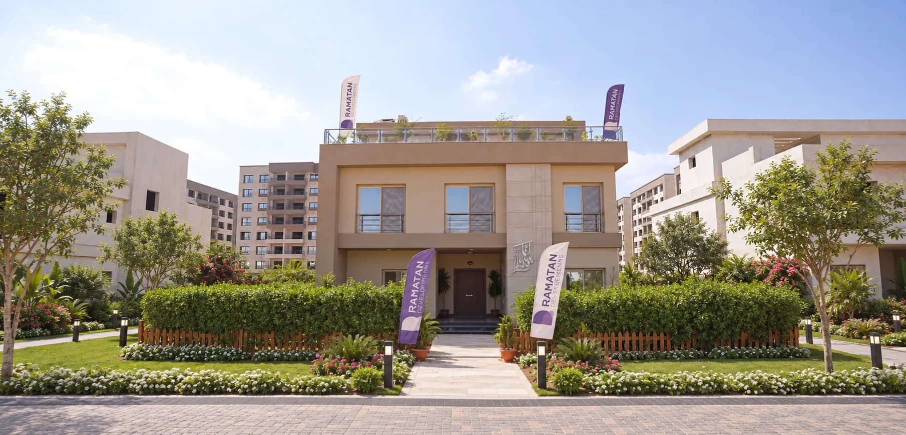 Close-up entrance to the modern villa with colorful flowerbeds and elegant wooden fences.